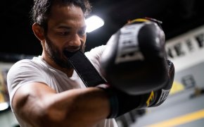 Benson Henderson strapping on his training gloves