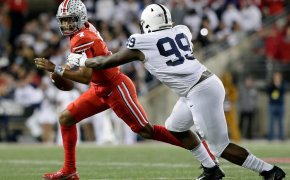 Ohio State Buckeyes quarterback C.J. Stroud is pursued by Penn State Nittany Lions defensive tackle Coziah Izzard