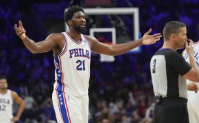 Joel Embiid arms out reaction to a referee call