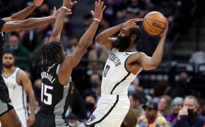 Brooklyn Nets guard James Harden driving to the basket against Sacramento Kings players.