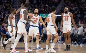 New York Knicks players high fiving each other on the court.