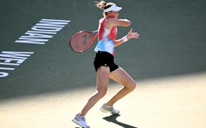 Elena Rybakina hitting a forehand shot during a tennis match.