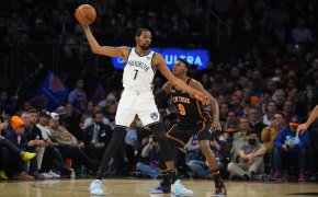 Knicks guard RJ Barrett defends Nets forward Kevin Durant.