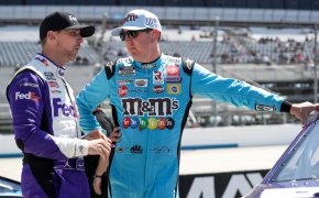 NASCAR Cup Series drivers Kyle Busch and Denny Hamlin talking on pit road