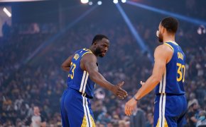 Draymond Green and Steph Curry low five