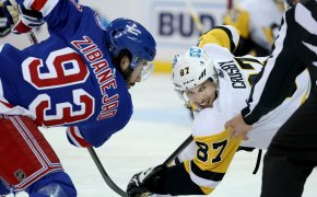 Pittsburgh Penguins center Sidney Crosby takes a face off against New York Rangers center Mika Zibanejad