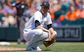 Colorado Rockies starting pitcher Kyle Freeland squatting on the field