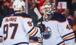 Edmonton Oilers goaltender Mike Smith and center Connor McDavid celebrating a win.
