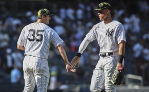New York Yankees relief pitcher Clay Holmes high-fiving outfielder Aaron Judge