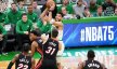 Boston Celtics forward Jayson Tatum holding the ball above his head