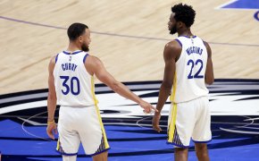 Golden State Warriors teammates Stephen Curry and Andrew Wiggins high-fiving