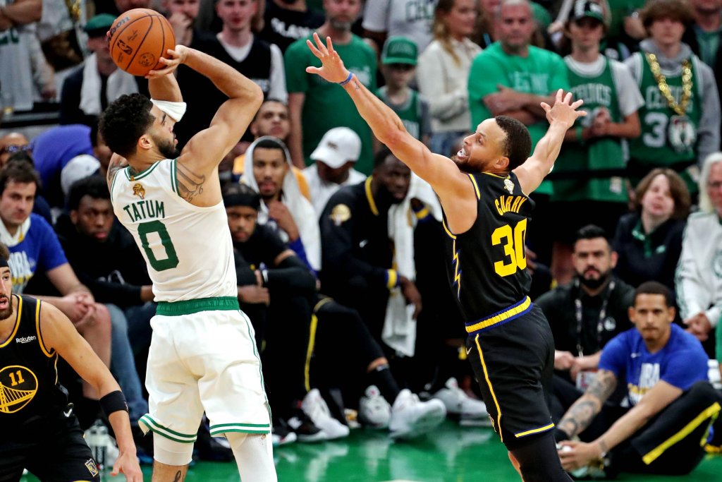 Jayson Tatum shooting basketball Steph Curry trying to block