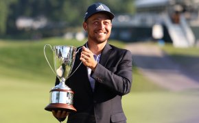 Xander Schauffele raising the Travelers Championship Trophy