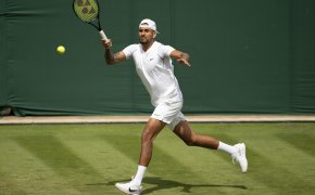 Nick Kyrgios (AUS) returns a shot during her first round match against Paul Gubb on day two of Wimbledon