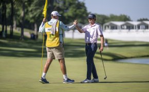 J.T. Poston shakes hands with his caddie after a round