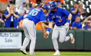 Toronto Blue Jays third baseman Matt Chapman celebrates with third-base coach Luis Rivera after hitting a home run