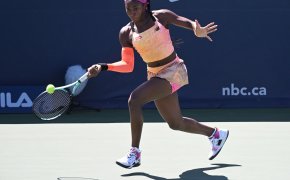 Coco Gauff hitting a return shot during a tennis match at the National Bank Open.