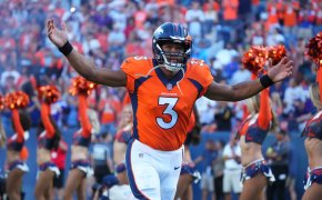 Denver Broncos quarterback Russell Wilson throws arms in the air
