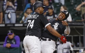 Eloy Jimenez and Elvis Andrus celebrate a home run