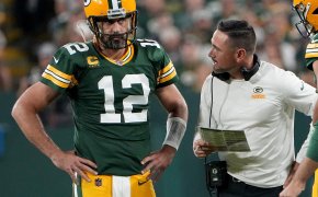 Packers QB Aaron Rodgers talks with his head coach