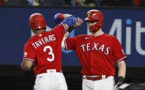 Texas Rangers center fielder Leody Taveras celebrates a home run with catcher Sam Huff