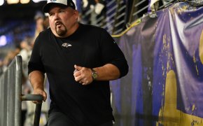 Baltimore Ravens offensive coordinator Greg Roman runs on the field