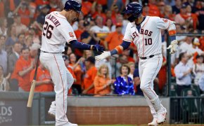 Houston Astros first baseman Yuli Gurriel high-fives designated hitter Trey Mancini