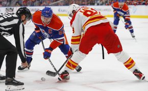 Edmonton Oilers forward Connor McDavid and Calgary Flames forward Name Kadri battle for a loose puck