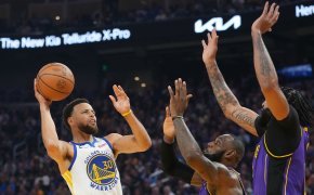 Steph Curry shoots over LeBron James and Anthony Davis