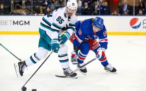 San Jose Sharks defenseman Erik Karlsson and New York Rangers left wing Artemi Panarin battle for the puck