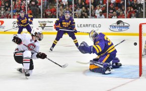 St. Cloud State's Grant Cruikshank gets the puck past Alex Tracy