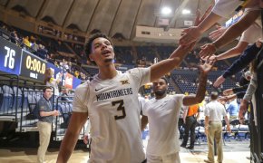 West Virginia Mountaineers forward Tre Mitchell high-fiving fans after a win