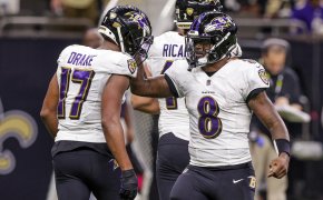 Baltimore Ravens quarterback Lamar Jackson congratulates running back Kenyan Drake