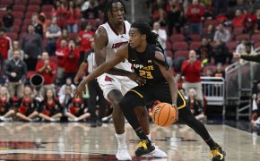 Appalachian State Mountaineers guard Terence Harcum holds off a defender