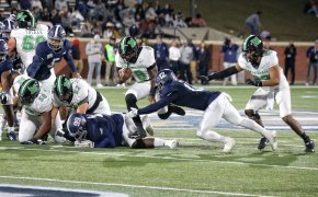 Marshall running back Khalan Laborn carries the football past safety