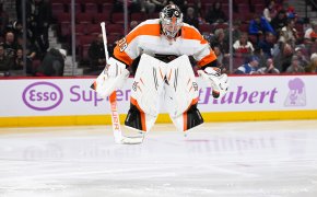 Philadelphia Flyers goalie Carter Hart jumps on the ice prior to the start of the second period