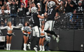 Las Vegas Raiders wide receiver Davante Adams celebrates with quarterback Derek Carr