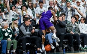 Northwestern's Chase Audige plows jumps into the crowd