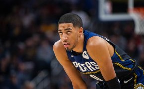 Indiana Pacers guard Tyrese Haliburton resting his hands on his knees during a game