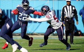 Tennessee Titans running back Derrick Henry wards off Houston Texans defensive end Jerry Hughes