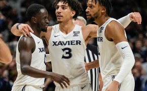 Xavier Musketeers players huddling during a game.
