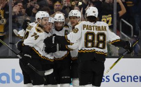 Boston Bruins center Patrice Bergeron is congratulated by teammates
