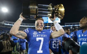 Kentucky's Will Levis grimaces while hoisting the 2022 Governor's Cup trophy