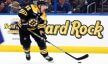 Boston Bruins left wing Brad Marchand skates and scores a goal