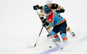 Sam Bennett, Matt Grzelcyk battle for puck; Bruins vs Panthers