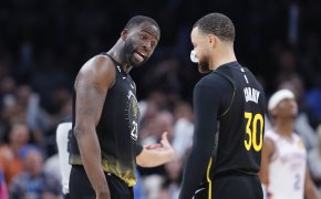 Golden State Warriors forward Draymond Green talks with guard Stephen Curry