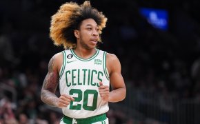 Boston Celtics guard JD Davison running hair flowing white green jersey