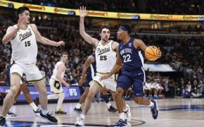 Penn State Nittany Lions guard Jalen Pickett holds off a defender