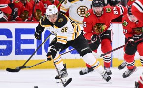 David Pastrnak skates with puck; Boston Bruins