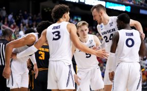 Xavier Musketeers players huddling on the court
